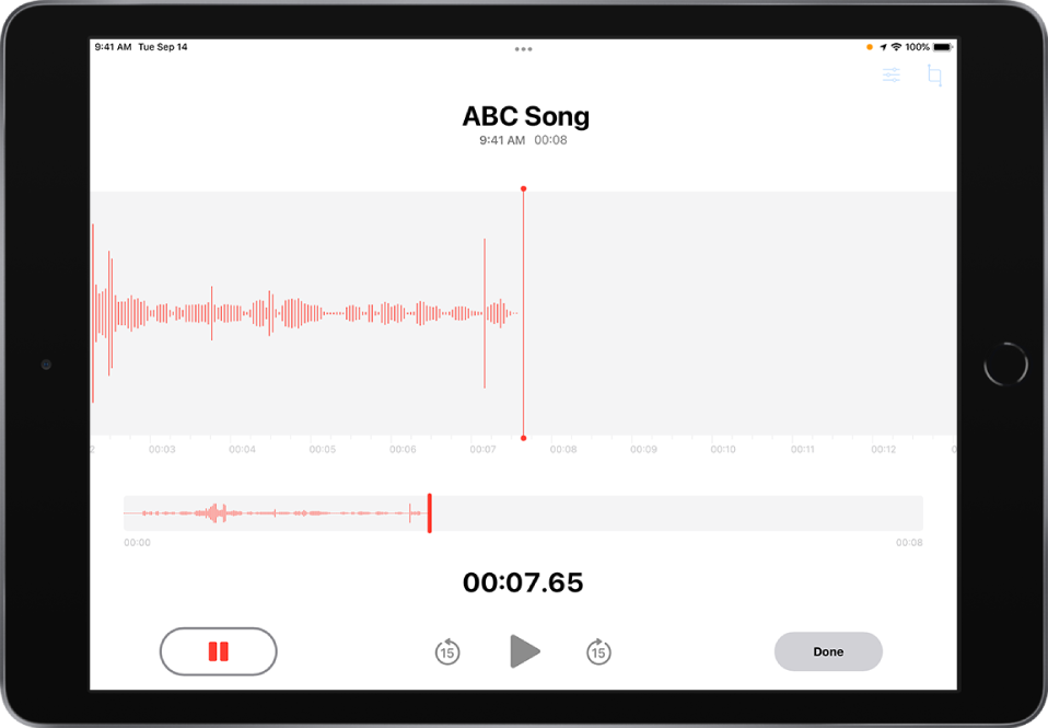 A Voice Memos recording in progress, with an active Pause button and dimmed controls for playing, skipping forward 15 seconds, and skipping backward 15 seconds. The main part of the screen shows the waveform of the recording that’s in progress, along with a time indicator. The orange Microphone In Use Indicator appears at the top right.