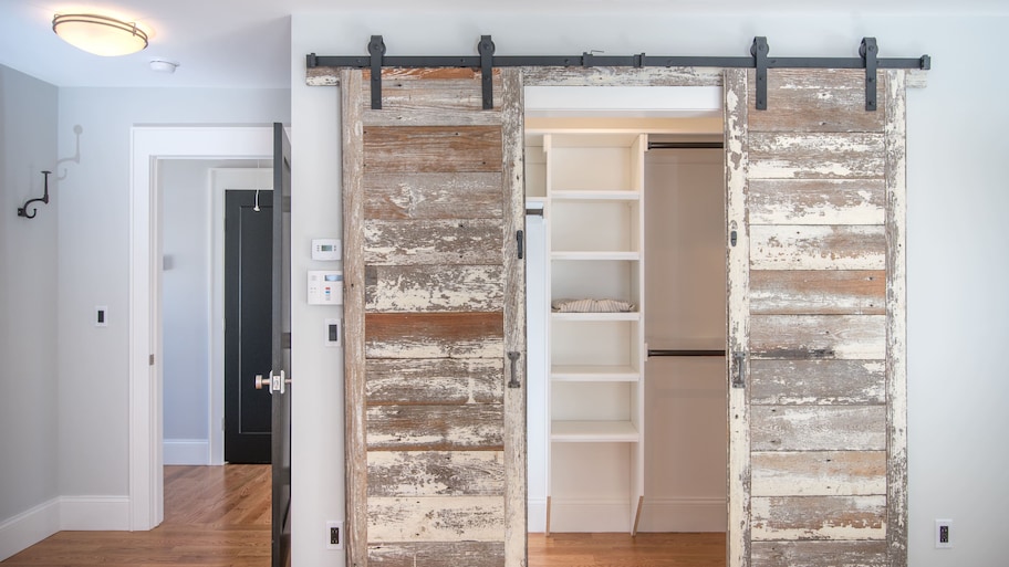 Rustic sliding barn doors leading to a closet