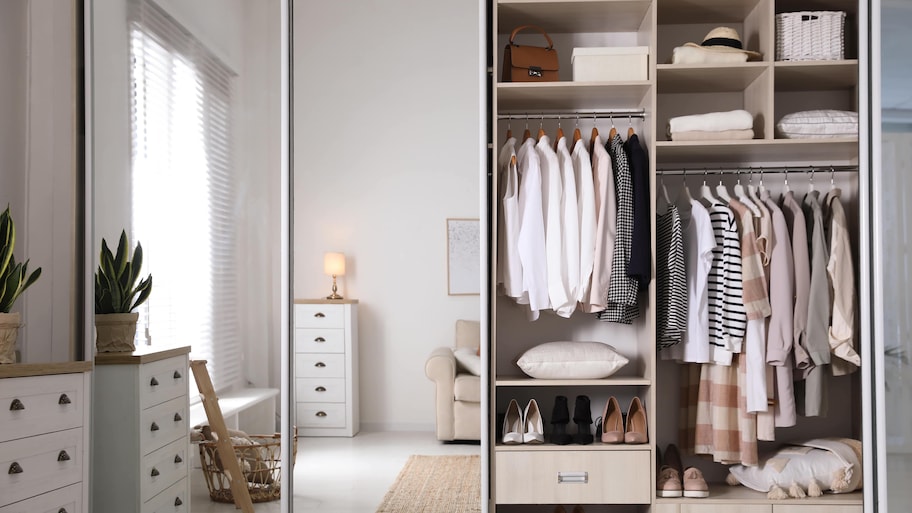 A bedroom with a set of sliding mirror closet doors