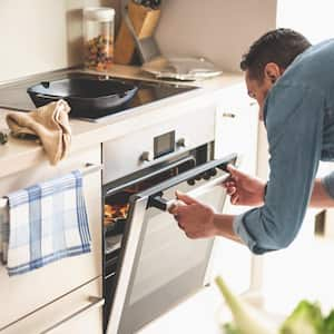 Man closing door of oven