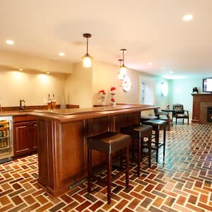 basement with bar and fireplace