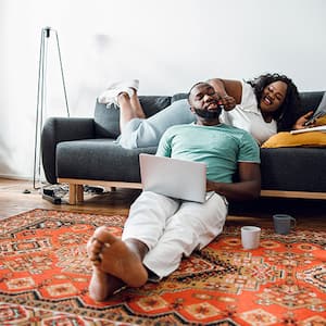 Couple sit on oriental rug