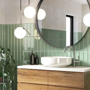 A contemporary bathroom with green subway tiles