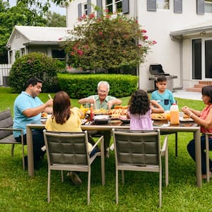 A family having dinner in the backyard of their house