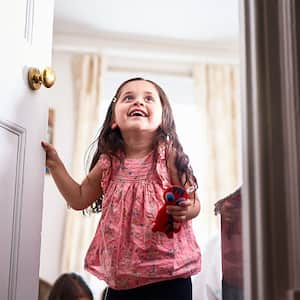 Girl opening door in house