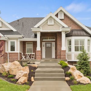 Brick house with new concrete steps and walkway