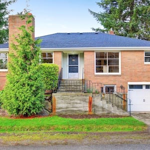 A two story red brick house with a garage