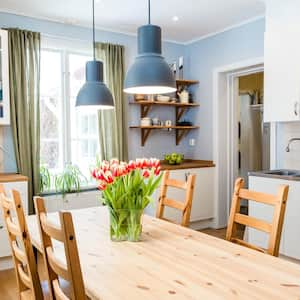 A kitchen with wooden floors and a wooden table