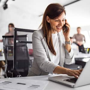 Woman at the office working on her laptop