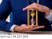 Young male employee in time management concept. Стоковое фото, фотограф Elnur / Фотобанк Лори