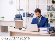 Young handsome employee working in the office. Стоковое фото, фотограф Elnur / Фотобанк Лори