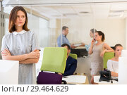 Unhappy tired young business woman standing in busy open plan office. Стоковое фото, фотограф Яков Филимонов / Фотобанк Лори