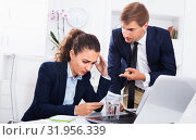 Sad subordinate woman being accused to making mistake by man colleague. Стоковое фото, фотограф Яков Филимонов / Фотобанк Лори