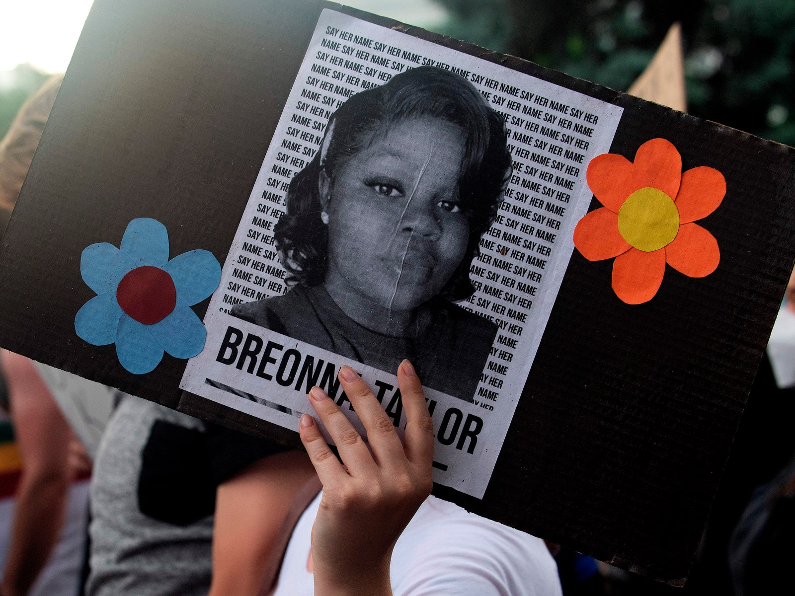 A demonstrator holds a sign with the image of Breonna Taylor in 2020.