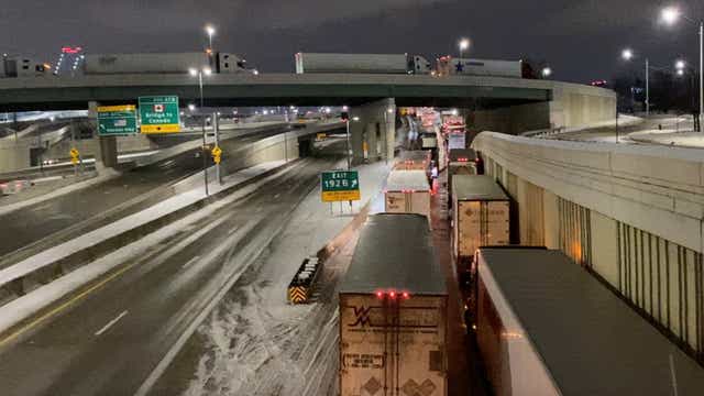 <p>Truckers stand in line as they block the Ambassador Bridge (not pictured) on the I-75 and I-96 highways in Detroit</p>
