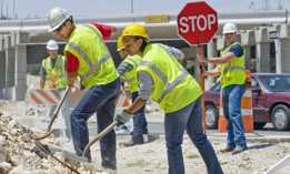 Construction workers, working on highway construction project.