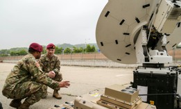 Maj. Ryan Collins (right), the 1st Special Forces Group (Airborne) signal officer, and Staff Sgt. Robert Carter, a satellite communications operator, troubleshoot a satellite antenna during a training exercise, April 28, 2018.