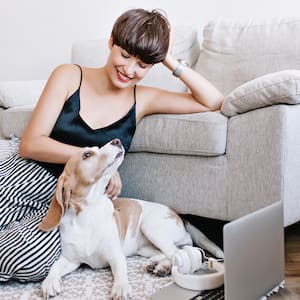 woman hanging out with dog in living room  