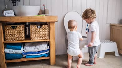 Children look at a toilet