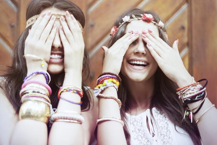 Boho girls with arms full of bracelets.