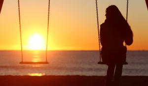 Woman alone on a swing.