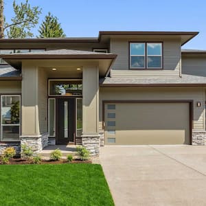 Suburban home with concrete driveway and green siding