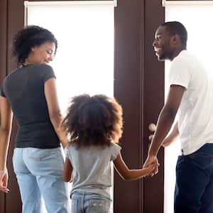 Happy family walking out the front door together