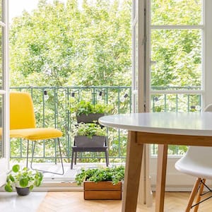 A view of a room with an open balcony door