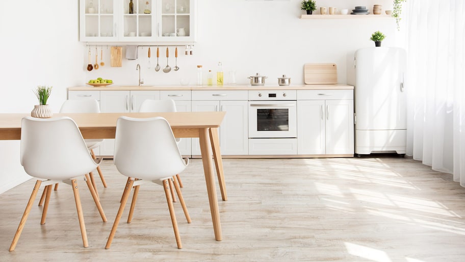 A Scandinavian kitchen with shelves and a wooden table