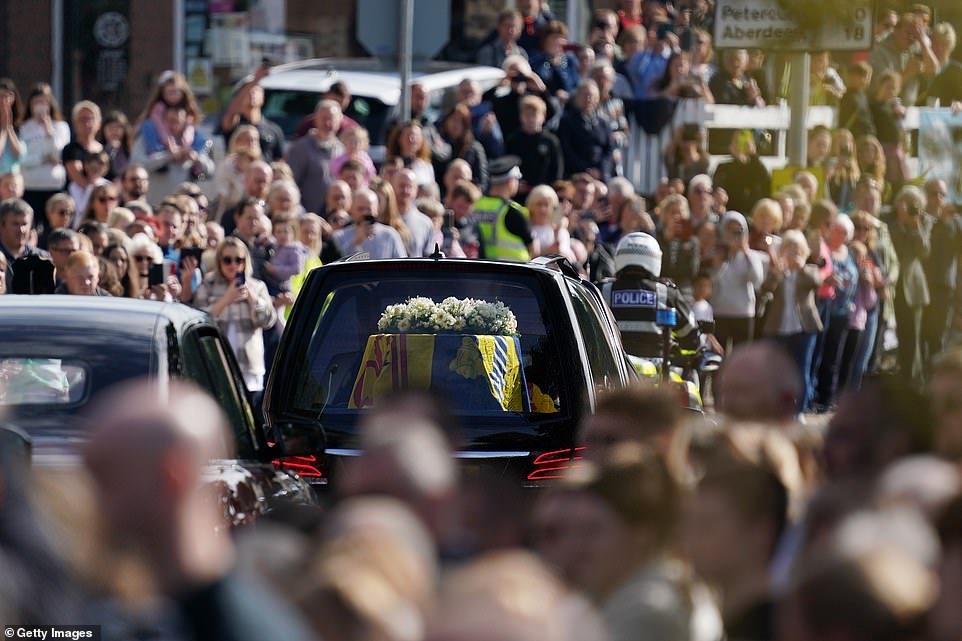 People in Banchory line the street as the Queen's coffin is driven from Balmoral to Edinburgh where it will lie in rest for 24 hours