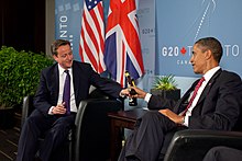 US President Barack Obama and British Prime Minister David Cameron exchange bottles of beer to settle a bet they made on the US vs. England World Cup football match (which ended in a draw), during a bilateral meeting at the G20 Summit in Toronto, Canada, Saturday, 26 June 2010
