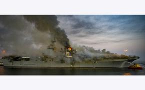 A fire continues to burn aboard the USS Bonhomme Richard (LHD 6) at Naval Base San Diego, July 12, 2020. 