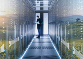 IT professional working on Dell laptop while managing Dell EMC servers, image overlaid with image of flowers in an open field.