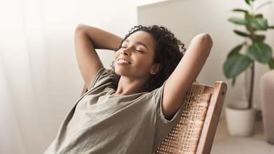 Woman relaxing at home in chair