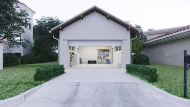 Concrete driveway leading to an open garage