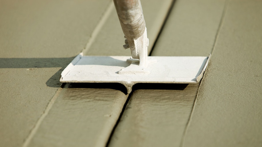 Groover Slicing Freshly Poured Concrete