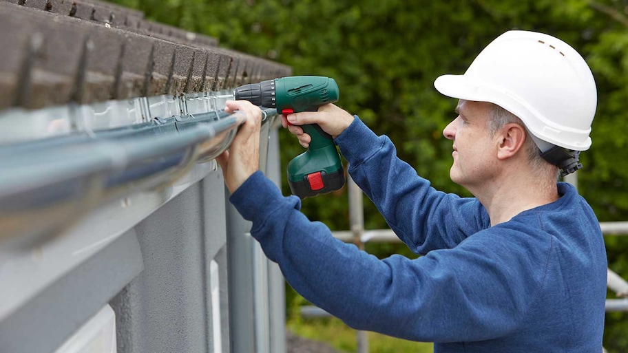 Person installing gutter