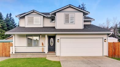 beige home with single driveway