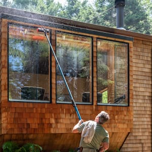A man cleaning a house window