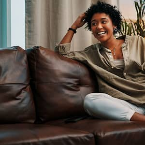 Woman sitting on leather couch