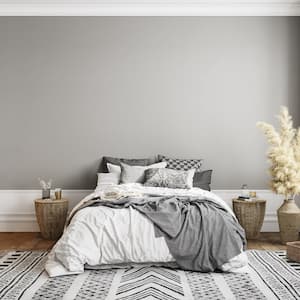 a furnished bedroom with gray walls