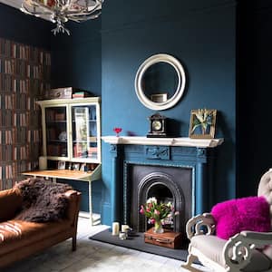 Moody blue den with architectural pieces