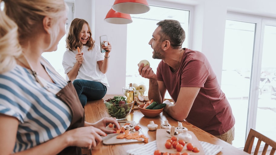 A family of three by the kitchen island in a bright kitchen