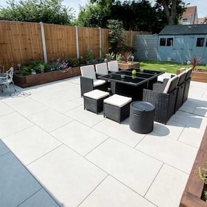 Backyard patio with porcelain pavers and outdoor furniture