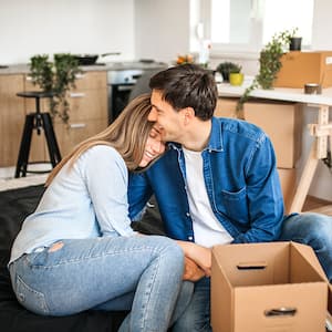 couple hugging settling into their new home 