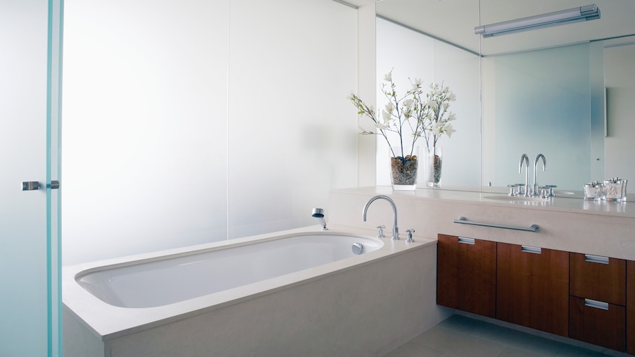 A modern bathtub in a bathroom with glass walls