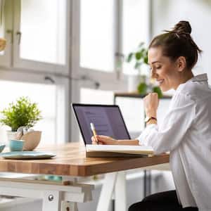 woman working on laptop in her home office 