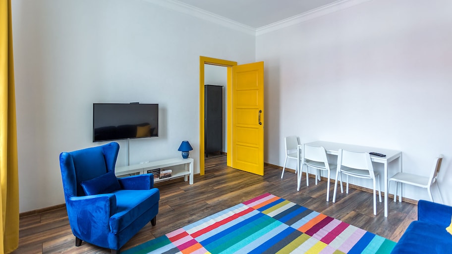 Living room with yellow door and blue sofa