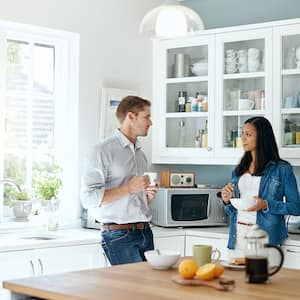 Couple talk in tidy, organized kitchen