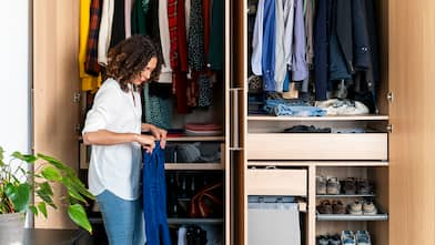 woman clearing out wardrobe 